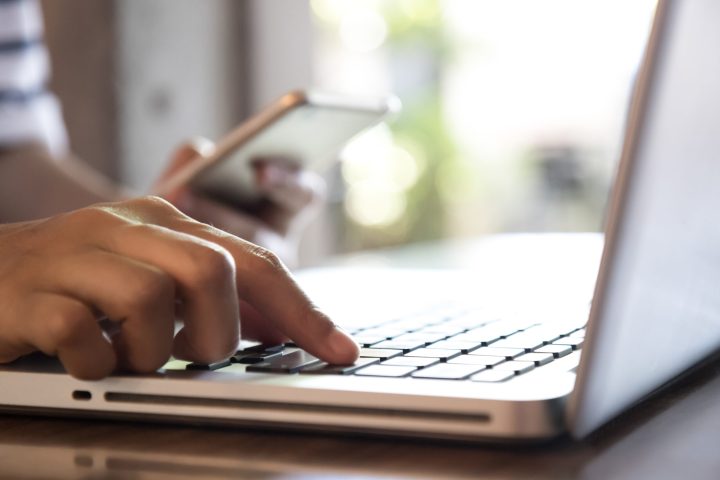 a close up of a person using a laptop computer