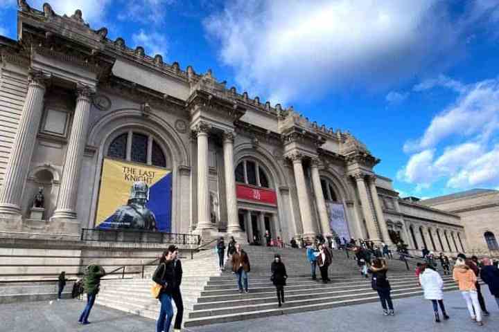 a group of people walking in front of a building